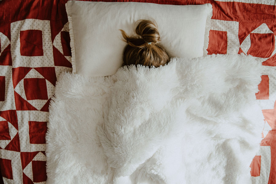 woman under bed covers