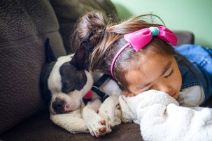little girl lying next to her dog, kids and pets