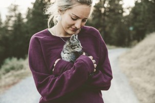woman holding kitten, pet owner
