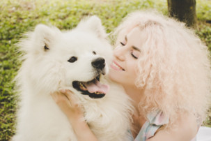 curly-haired woman with white dog, how to bond with your dog