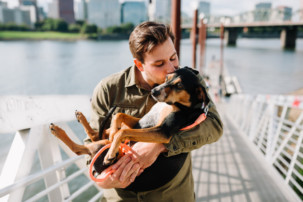 man carrying dog, dog love, pet parent, first-time pet owner