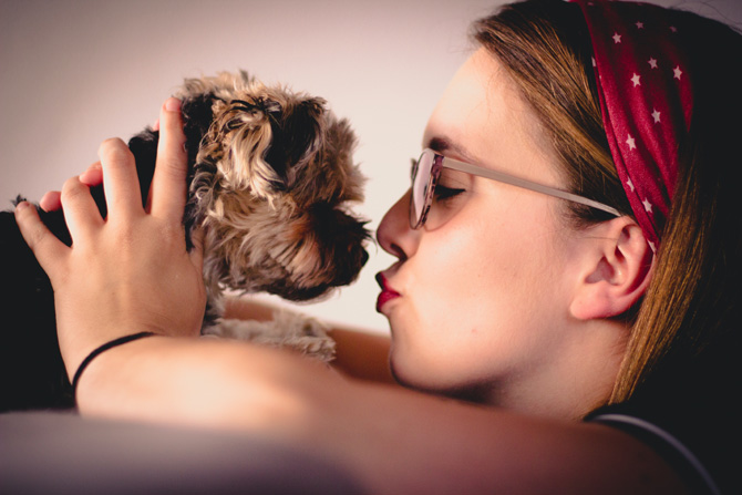 woman kissing terrier, best pet insurance